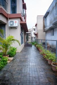 a brick walkway leading to a building with plants at Villa 29 - 3BHK Villa with Private Pool in Khopoli in Pali