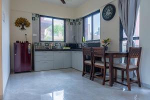 a kitchen with a refrigerator and a table and chairs at Villa 29 - 3BHK Villa with Private Pool in Khopoli in Pali