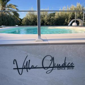 a sign on the side of a swimming pool at VILLA GIUDICE Luxury Home with Private Pool in Priolo Gargallo