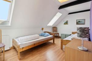 a large room with a bed and a table at Holiday Apartment With Sea View, Near The Beach in Lebøl