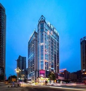 a tall building in a city at night at Lavande Hotel Duyun Dashizi Wenfeng Park in Duyun