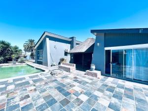 a house with a patio and a swimming pool at Enez Place in Gqeberha