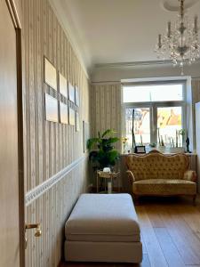 a living room with a couch and a chair at Riga Old Town 2 Bedroom and Office ArtDeco Apartment with Wifi and TV in Rīga