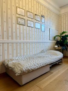 a bedroom with a bed and a wall with wallpaper at Riga Old Town 2 Bedroom and Office ArtDeco Apartment with Wifi and TV in Rīga