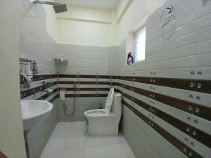 a bathroom with a toilet and a sink at JAP Guest House & Apartments in Pokhara +70 photos