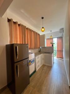a kitchen with a refrigerator and a stove in it at Euphoria Villa in Hikkaduwa