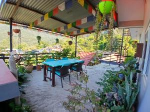 a patio with a blue table and some plants at JAP Guest House & Apartments in Pokhara