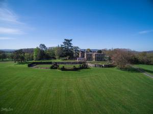 an aerial view of a large house in a field at Burton Court in Dilwyn