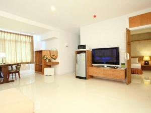a large living room with a television and a table at G2 Hotel Group in Ban Kohong