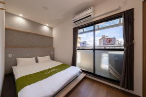 Postel nebo postele na pokoji v ubytování 青羽-橘山