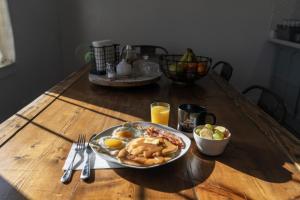 a wooden table with a plate of breakfast food on it at Bryce Canyon Log Cabins in Tropic +23 photos