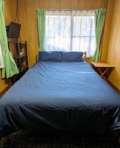 a bed in a room with a large window at 伊根の宿 汐風 Shiokaze in Nomuro +36 photos