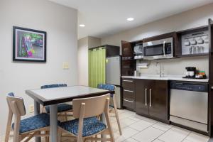 a kitchen with a table and chairs in a room at Home2 Suites by Hilton Ridgeland in Ridgeland