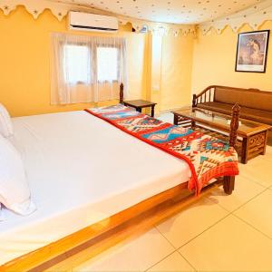 a bedroom with a large bed and a table at Prakriti Farms in Rūpnagar +77 photos