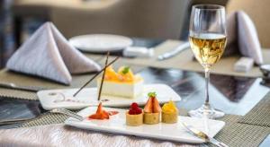 a glass of wine next to a plate of food at Shanghai Fuyue Hotel in Songjiang