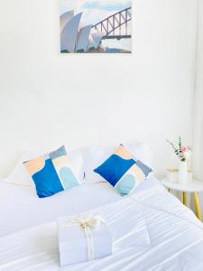 Una cama blanca con una caja encima. en The Sunset Exclusive Top Floor, en Chonburi