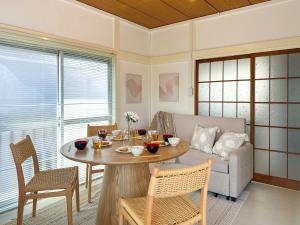 a living room with a table and a couch at #39 Ukimafunado in Tokyo