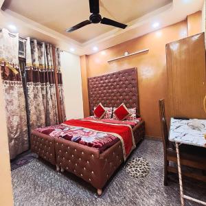 a bedroom with a large bed with red pillows at Hotel The Deep Presidency in Jāmb