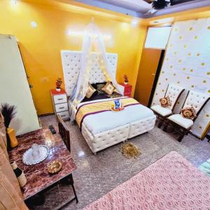 a bedroom with a bed and a table at Hotel The Deep Presidency in Jāmb