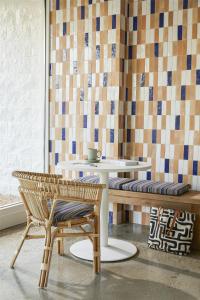 a room with a table and a bench and tiles at Avatar Hotel Santa Clara, Tapestry Collection by Hilton in Santa Clara