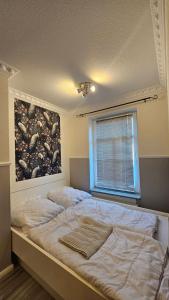 a bedroom with a bed with a painting on the wall at Am Obstgarten in Hinte