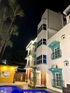 a building with a pool in front of it at night at LuXus Resort & Swimming Pool in Pondicherry