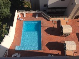 an overhead view of a swimming pool on a building at Lila's Beach Apartment in São Roque