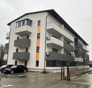 a building with a car parked in a parking lot at AN Studio in Craiova