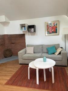 a living room with a couch and a table at Charmant Mazet en campagne provencale in Châteaurenard