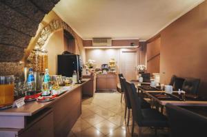 a restaurant with a bar with a table and chairs at Hotel De Rosewood Inn -Near Delhi Airport-Free Airport Drop in New Delhi