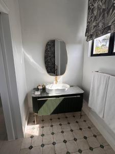 a bathroom with a sink and a mirror at Plettenvale Wines in Plettenberg Bay +105 photos