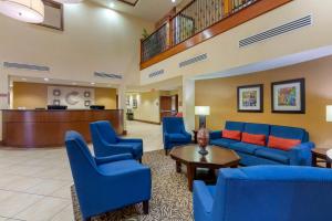 a lobby with blue chairs and a waiting room at Comfort Suites Charleston West Ashley in Charleston