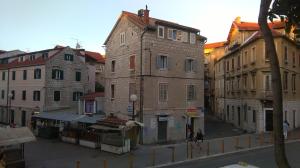 a group of buildings on a city street at Contarini Apartment in Split