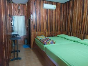 a small bedroom with a bed and a window at Bamboo River House Kaengkrachan in Ban Nong Chaeng +80 photos