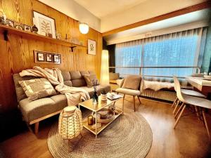 a living room with a couch and a table at Suite Albare, Marilleva 1400, Val di Sole in Marilleva +26 photos