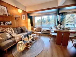 a living room with a couch and a table at Suite Albare, Marilleva 1400, Val di Sole in Marilleva