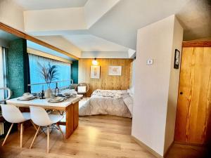 a bedroom with a bed and a table and chairs at Suite Albare, Marilleva 1400, Val di Sole in Marilleva