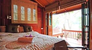 a bedroom with a large bed and a large window at Doembang Villa in Ban Tha Pong +229 photos