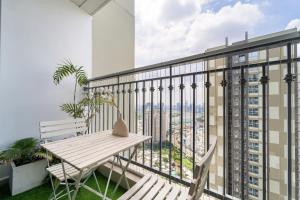 a balcony with a bench and a view of the city at Landmark Signature Residences Ori-Stay in Kon Rung (1)