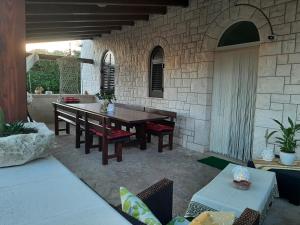 Un patio con mesa y sillas y un muro de piedra. en Villa Bellocchio, en Locorotondo 37 fotos más