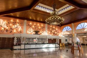 a large lobby with a chandelier and a reception at Sandos Playacar All Inclusive in Playa del Carmen