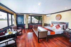 a bedroom with a large bed and a table and chairs at Starlight Cruise Ha Long in Ha Long +8 photos