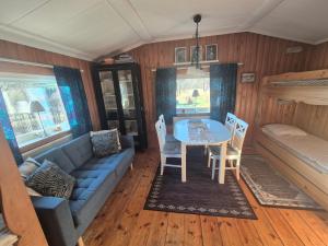 a living room with a couch and a table at Backamgården in Sälen