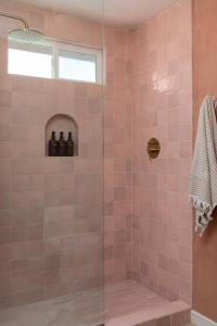 a pink tiled shower with a glass door at Stylish, Spa, Cowboy Pool Flamingo Social Club in Yucca Valley +44 photos