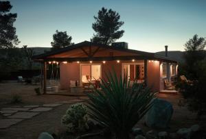 a small house with lights on the front of it at Stylish, Spa, Cowboy Pool Flamingo Social Club in Yucca Valley