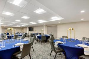 a conference room with blue tables and chairs at Comfort Inn & Suites Newark Liberty International Airport in Newark