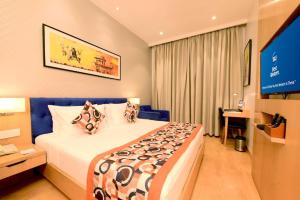 a hotel room with a large bed and a television at hotel Linda Grand Near Delhi Airport, A Block road no 6 street No 12 Mahipalpur New Delhi in New Delhi +11 photos