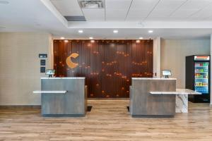 a lobby with two desks in front of a wooden wall at Comfort Inn & Suites in Bradford +37 photos