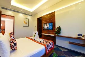 a bedroom with a bed and a flat screen tv at hotel Linda Grand Near Delhi Airport, A Block road no 6 street No 12 Mahipalpur New Delhi in New Delhi