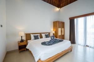 Ένα ή περισσότερα κρεβάτια σε δωμάτιο στο Ulu dawa Pandawa Cottage +25 φωτογραφίες